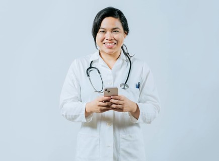 Young asian female doctor holding phone looking at camera isolated, Concept of online medical