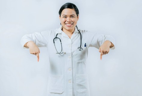 Young asian female doctor recommending an advertisement. Asian female doctor pointing at medical