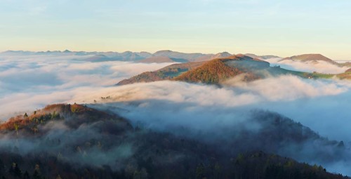View from the Gisliflue of the Jurassic foothills covered in fog with the water fluh in the morning
