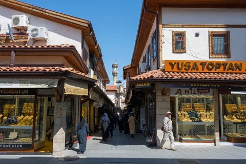 Lively market street with traditional shops and passers-by on a sunny day, jewelry shops, Konya,