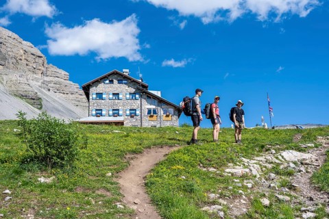 Hikers in front of Rifugio Graffer, Brenta, Brenta-Adamello Natural Park, Trentino, Italy