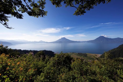 Lake Atitlán or Lake Atitlán in the morning, in the back the volcanoes San Pedro, Atitlán and