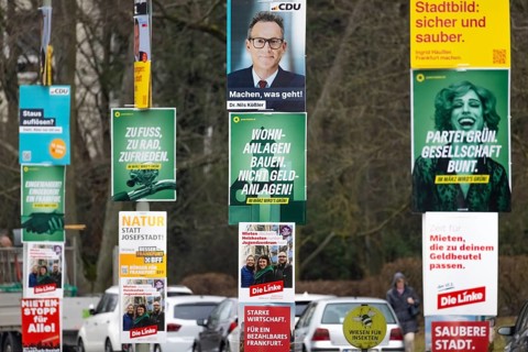 Numerous election posters for the 2026 local elections are hanging one behind the other on several