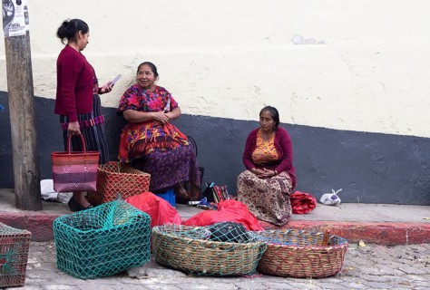 Mayan woman wearing traditional clothing sell chickens on the street in Chichicastenango,