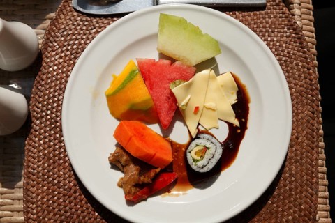 Rich Asian breakfast at the hotel with fruits and vegetables, Ubud, Bali, Indonesia
