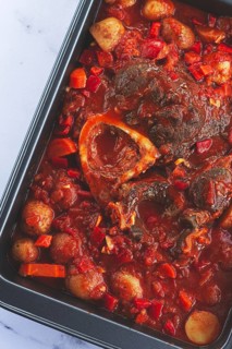 Ossobuco stew with vegetables, knuckle on the bone with new potatoes, in tomato sauce, homemade,