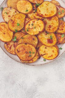 Crispy potato slices, with parmesan cheese and spices, fried in the oven, homemade, no people