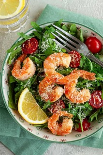 Shrimp salad with arugula and cherry tomatoes, with parmesan cheese, healthy food