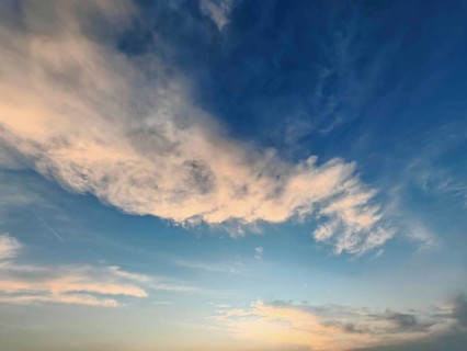 Blue sky with white clouds in soft evening light, Germany
