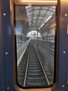 View from train window of abandoned train tracks in the train station, Prague