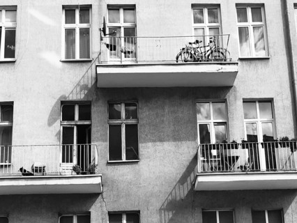 Multi-storey building with balconies and bicycles, urban atmosphere, Poland