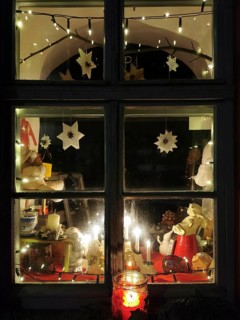 A Christmassy decorated window with atmospheric lighting and garland of lights, Franconian Forest