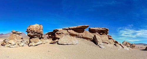 Wide panoramic view of impressive rock formations in the desert under a blue sky, The landscape of