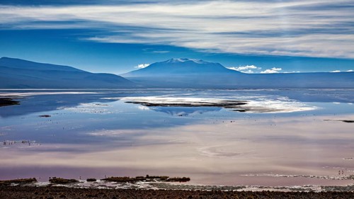 Dramatic cloud formations over a reflecting lake and distant mountain ranges, The Laguna Colorada