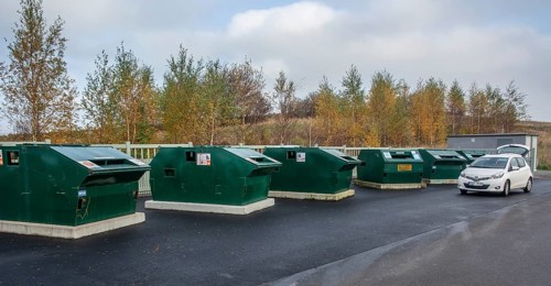 Garbage station with garbage containers for various waste in Ystad, Skåne County, Sweden,