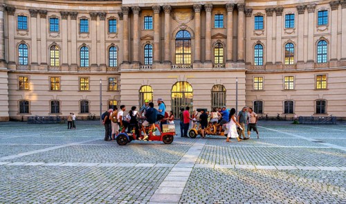 Tourist group with guides on Bebelplatz in Mitte, Berlin, Germany
