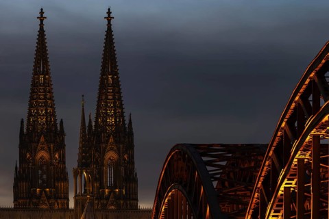 Evening atmosphere, Cologne Cathedral illuminated with LED lamps and the Hohenzollern Bridge,