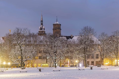 Winter in Stuttgart. The city is wintry white early in the morning. Castle square with collegiate