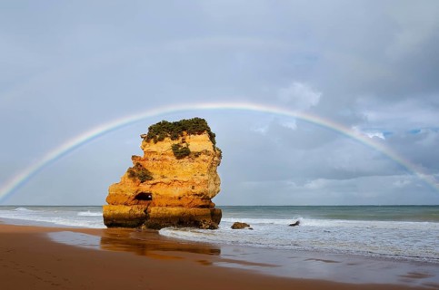 Rocks on beach with rainbow, Praia Dona Ana, Lagos, Algarve, Portugal