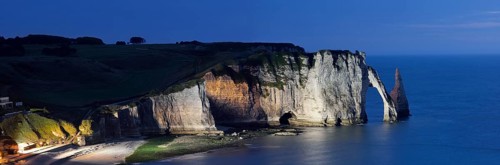 Cliff with the Falaise d'Aval rock gate and the Aiguille d'Etretat rock pin at night, Etretat,