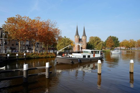 Oostpoort city gate and ship on the Delftse Schie, Delft, South Holland, Netherlands