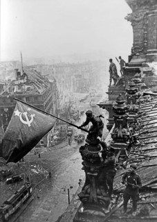 At the Berlin Reichstag, May 2, 1945, three Soviet soldiers fly the flag of the Soviet Union. The