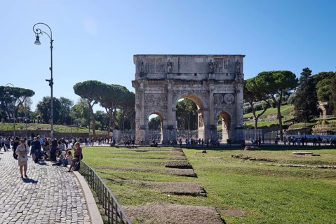 Arch of Constantine with tourists on sunny day, Lazio, Italy