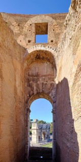 View through round arch of Constantine's Arch from the Colosseum, Rome, Lazio, Italy