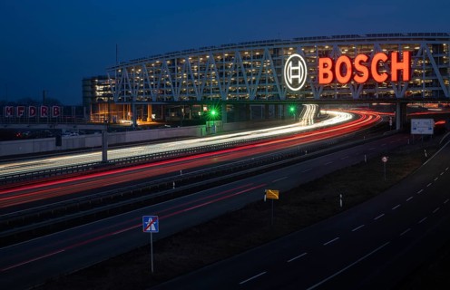 Traffic on the A8 motorway, blue hour, illuminated parking garage, Landesmesse Stuttgart, red-lit