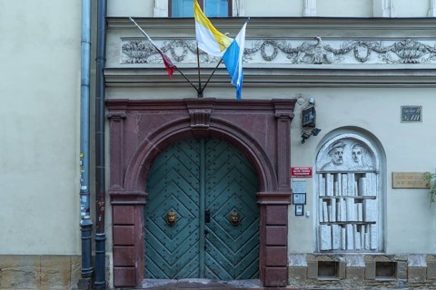 Historic entrance portal with a relief of a bookshelf, Krakow, Poland