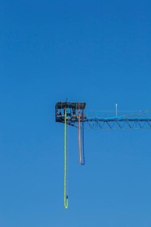 Montreal Bungee Tower installation with dangling long yellow elastic bungee jumping cord, Old Port