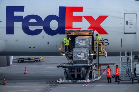 FedEx Express Boeing 777-FS2 cargo plane is unloaded, air freight container, air freight center at