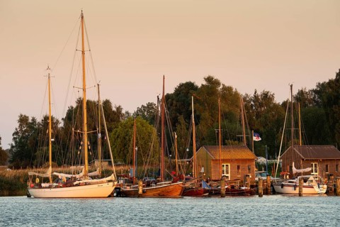 Sunset with boat on the lagoon near Gager on Rügen, Rügen, Gager, Mecklenburg-Western Pomerania,