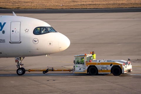 Lufthansa City Airbus A320neo is pushed from the gate onto the taxiway, ready to go, to