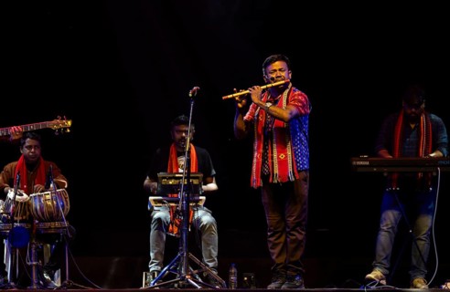Flutist Dilip Hira performs during a cultural evening program at Shilpgram Mohotsav 2026 in