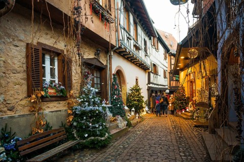 Christmassy decorated houses and alley with half-timbered houses, Christmas market, Eguisheim,
