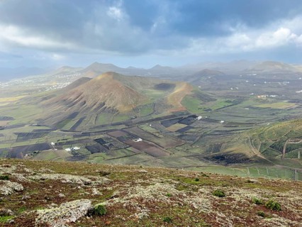 View of Montaña Tesa volcano from Montaña Blanca mountain with cloudy sky, Lanzarote, Canary