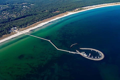 Aerial view over Seebrücke, pier and marina with boats at seaside resort Prerow along the Baltic