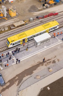 Bird's eye view of yellow train on a busy platform, taking off the Hermann Hesse Railway, Calw,
