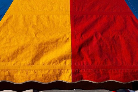Close-up of yellow, red and blue dyed canvas cloth material, Quebec, Canada