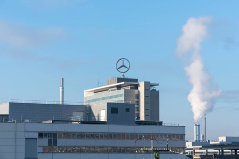 Modern building with Mercedes logo and rising steam under a clear sky, Mercedes Star,