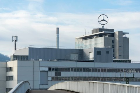 Building with Mercedes logo and cloudy sky, modern architecture, Mercedes Star,