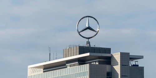 Modern building with Mercedes-Benz logo under cloudy sky, Mercedesstern, Stuttgart-Untertürkheim,