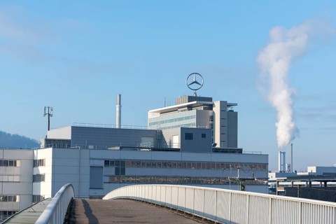 Building with Mercedes logo and rising steam, bridge in the foreground, Mercedes Star,