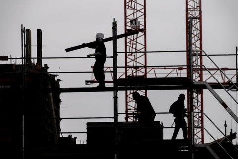 Construction site, scaffolding work on a large construction project, apartments and commercial