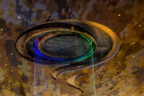 Artificial, brightly lit waterfall, Magic Waterfall, falls from the ceiling of the Iconsiam