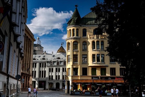 Historic buildings on Livu Square in Riga, including the Cat House, in sunny skies, Riga, Latvia