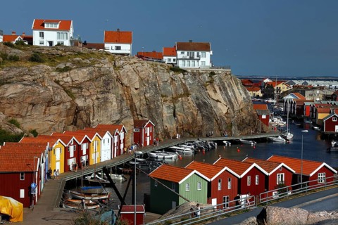 Colourful boathouses along the rocky coast with sea views, Smögen, Västra Götaland, Sweden