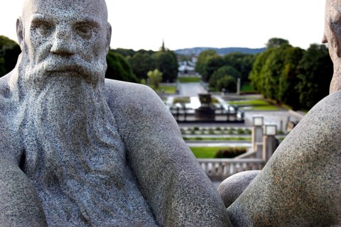 Granite figures in Vigeland sculpture park with green parkland in the background, Oslo, Norway