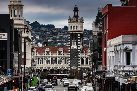 Historic train station surrounded by busy streets and distinctive architecture in Dunedin, Dunedin,